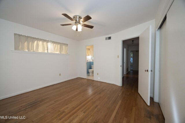 spare room with ceiling fan and dark hardwood / wood-style floors