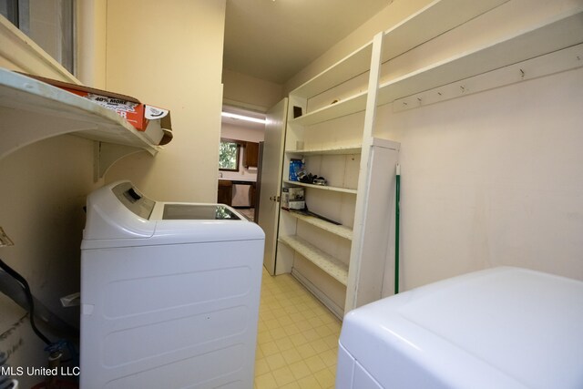 washroom featuring washing machine and dryer