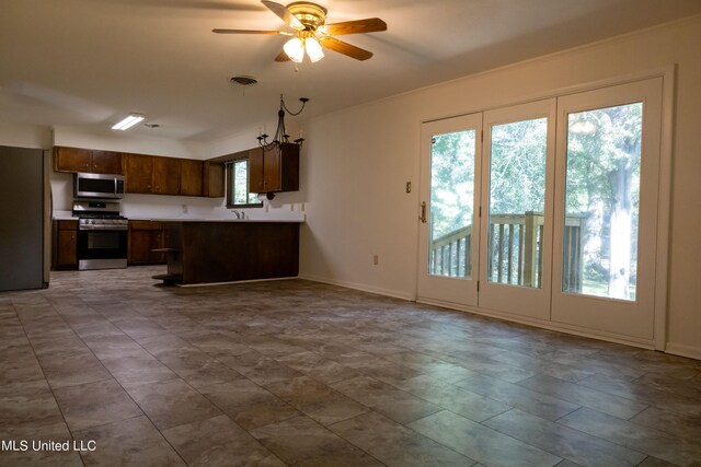 kitchen featuring ceiling fan, stainless steel appliances, dark brown cabinetry, and sink