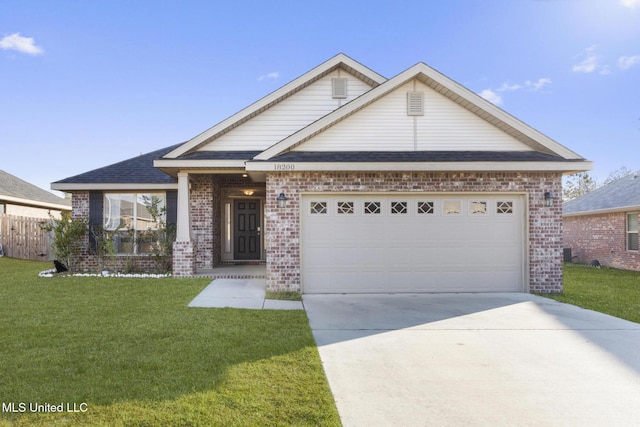 view of front of property with a front yard, concrete driveway, brick siding, and an attached garage