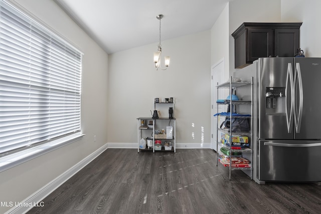 dining space featuring baseboards, a notable chandelier, and dark wood-style floors