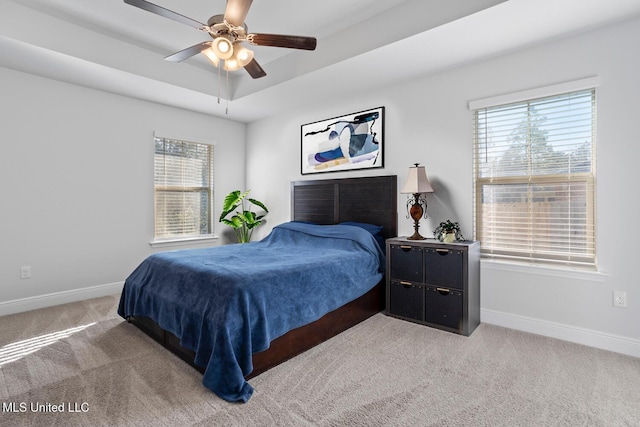 bedroom featuring multiple windows, baseboards, and carpet