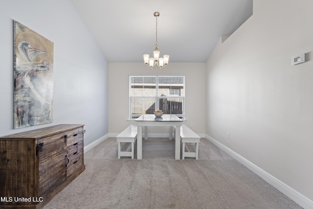 unfurnished dining area featuring lofted ceiling, baseboards, carpet floors, and a chandelier