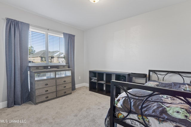 bedroom featuring baseboards and carpet