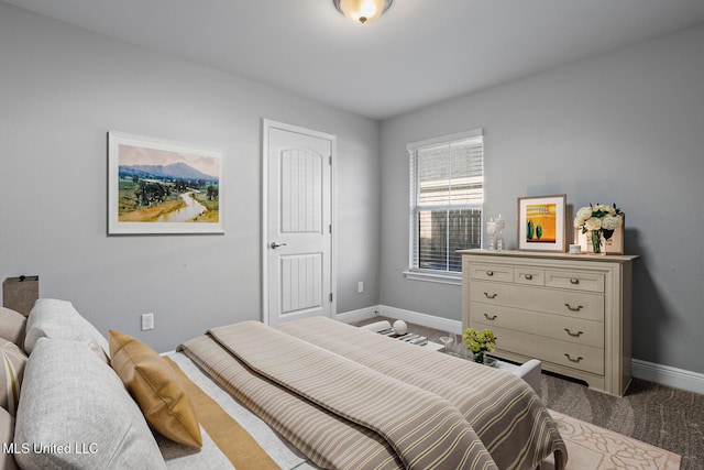 carpeted bedroom featuring baseboards