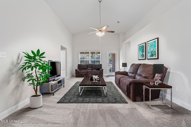 living room with baseboards, carpet flooring, high vaulted ceiling, and ceiling fan