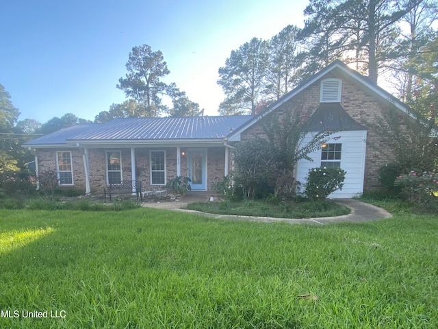 single story home with covered porch and a front yard