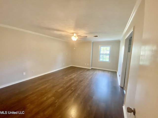 empty room featuring dark hardwood / wood-style flooring, ceiling fan, and crown molding