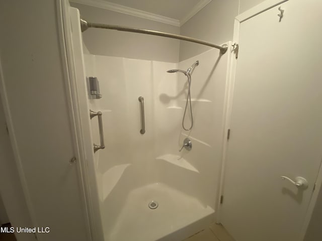 bathroom with walk in shower and ornamental molding