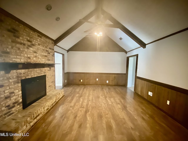 unfurnished living room with ceiling fan, light hardwood / wood-style flooring, vaulted ceiling, and a brick fireplace