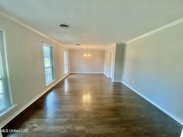 unfurnished room with a chandelier, a textured ceiling, and ornamental molding