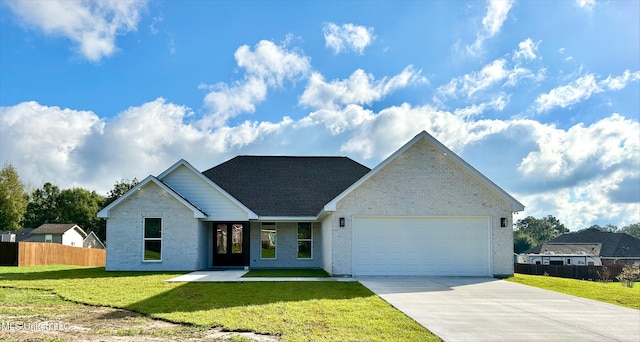 view of front of home featuring a front lawn and a garage