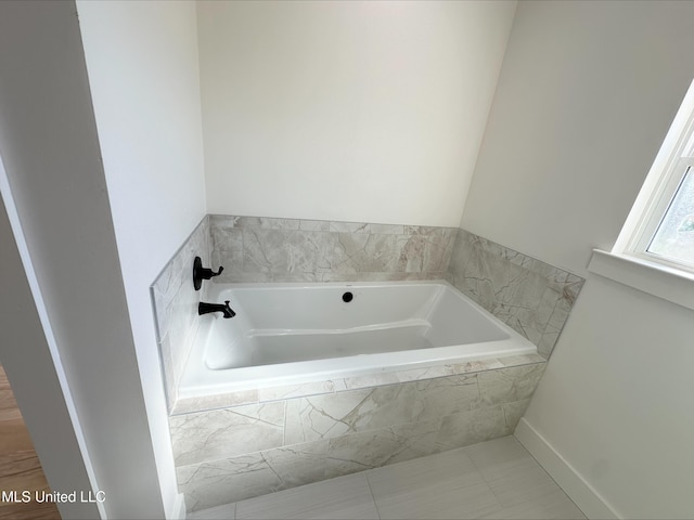 bathroom with tiled tub