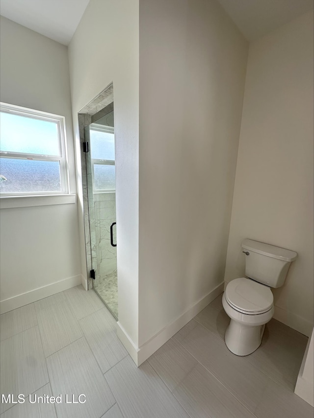 bathroom featuring an enclosed shower, toilet, and tile patterned floors