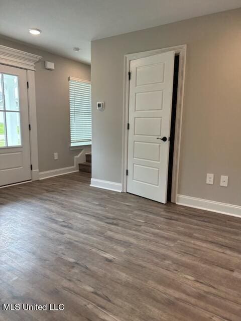 unfurnished room with hardwood / wood-style flooring