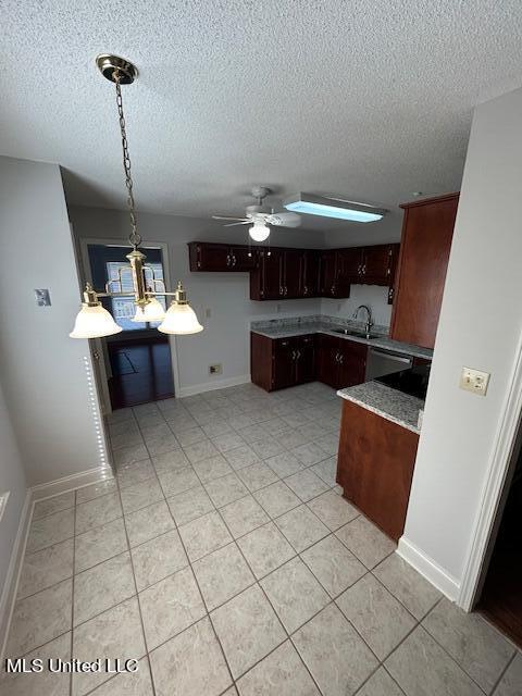 kitchen with sink, a textured ceiling, light tile patterned floors, and ceiling fan