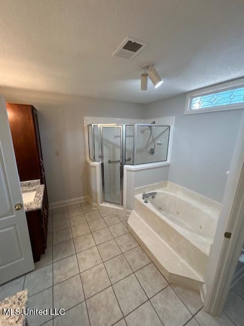 bathroom featuring vanity, independent shower and bath, and tile patterned floors