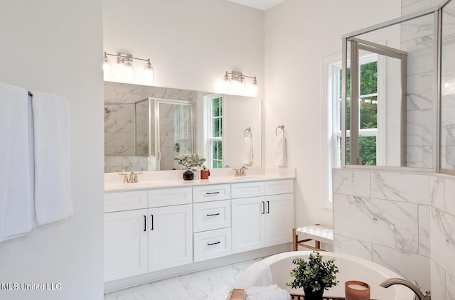 bathroom with vanity and separate shower and tub