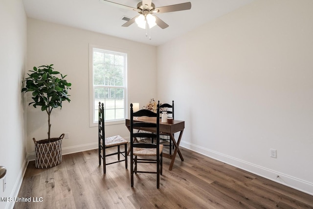 dining space featuring wood-type flooring and ceiling fan