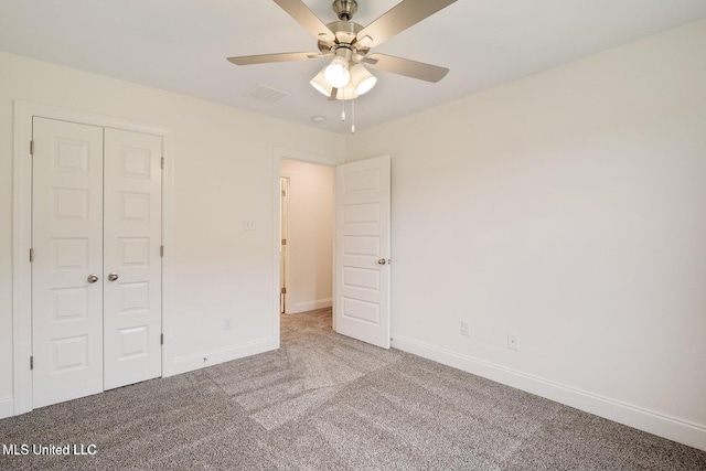 unfurnished bedroom with ceiling fan, light carpet, and a closet