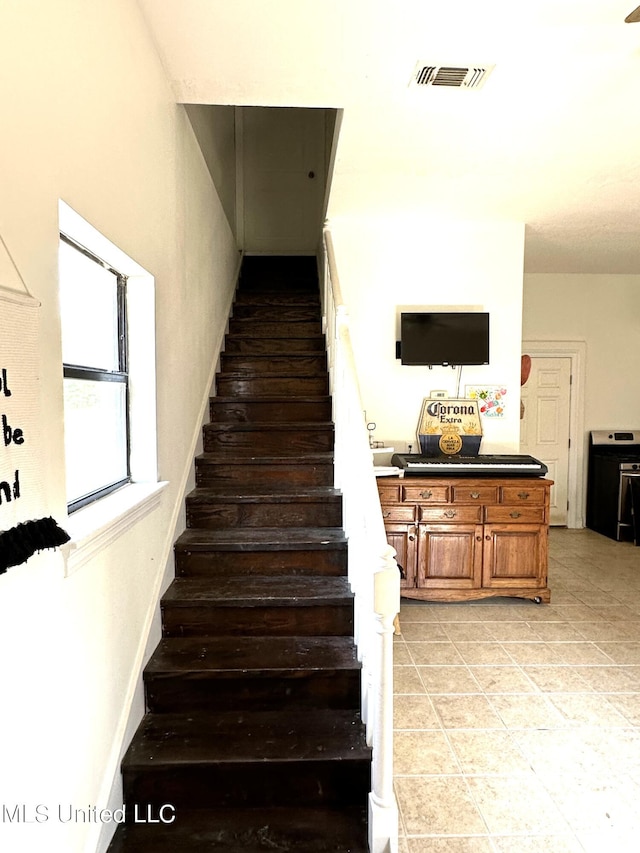 staircase with tile patterned flooring