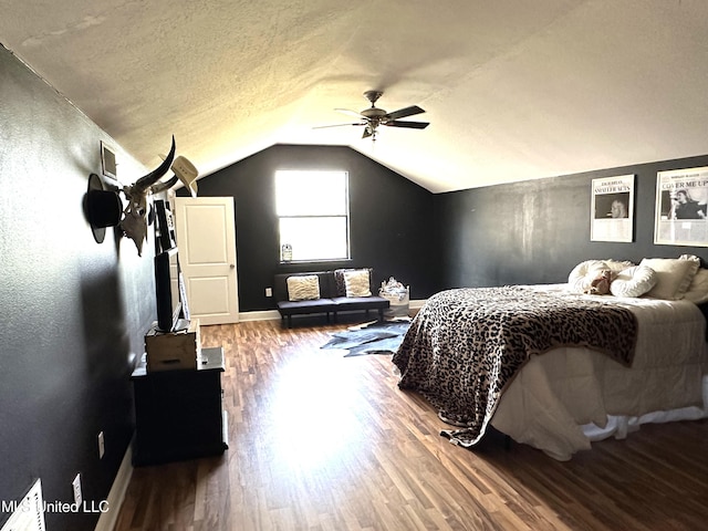 bedroom featuring hardwood / wood-style floors, ceiling fan, a textured ceiling, and lofted ceiling