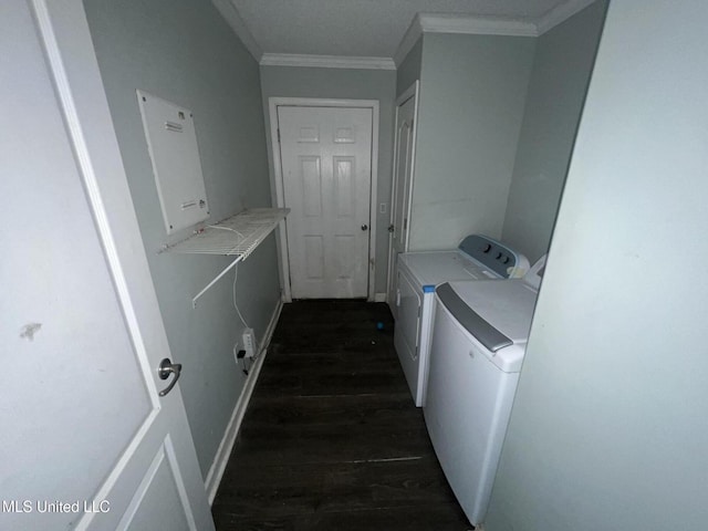 laundry room featuring laundry area, washer and dryer, crown molding, and dark wood-type flooring