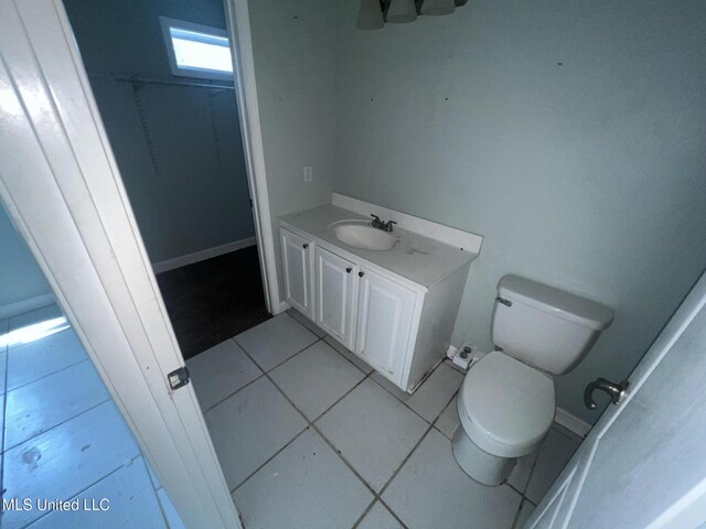 bathroom featuring toilet, vanity, and tile patterned flooring