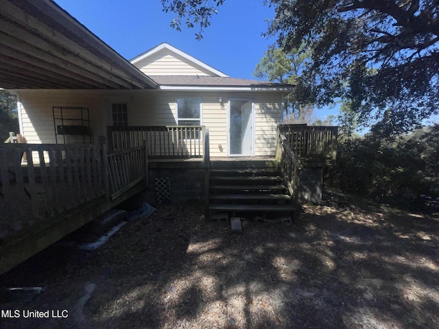 back of property featuring a deck