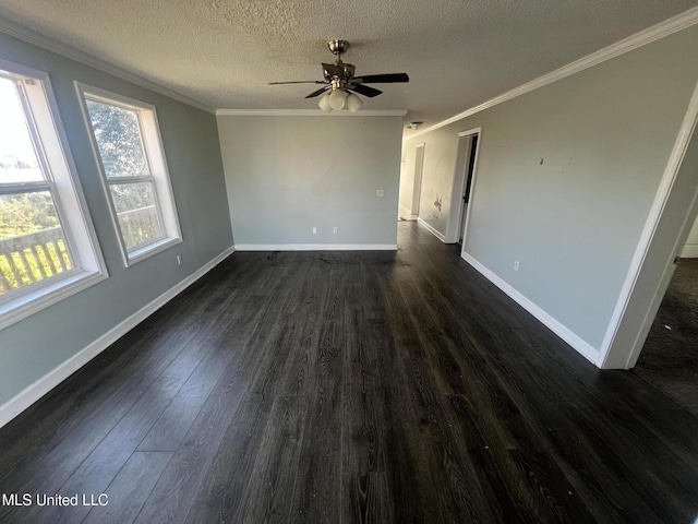 empty room featuring baseboards, dark wood finished floors, ornamental molding, a textured ceiling, and a ceiling fan