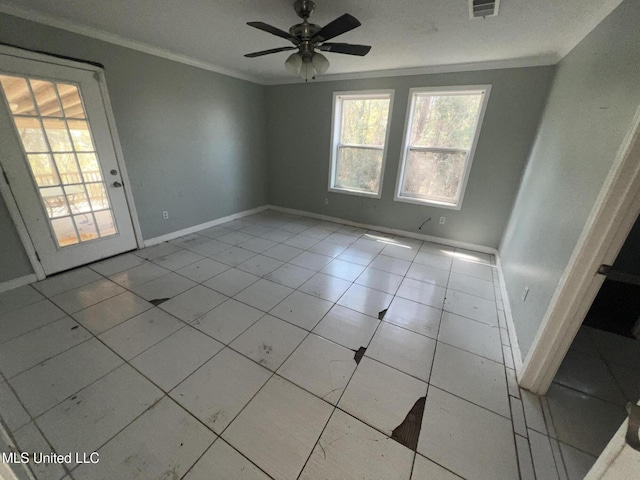 spare room with visible vents, a ceiling fan, crown molding, and baseboards