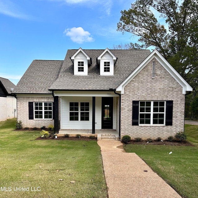 view of front facade featuring a front lawn and covered porch