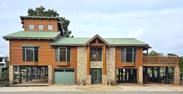 log-style house with a garage and a deck