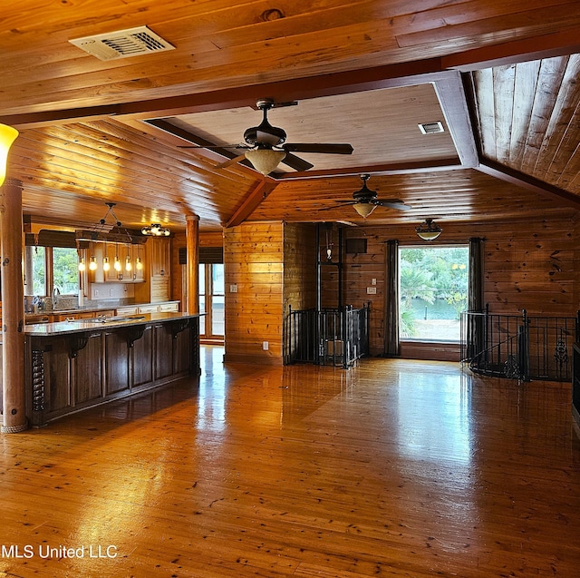 unfurnished living room with a wealth of natural light and wooden ceiling