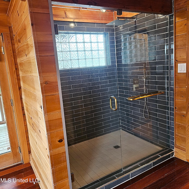 bathroom featuring hardwood / wood-style floors and a shower with door