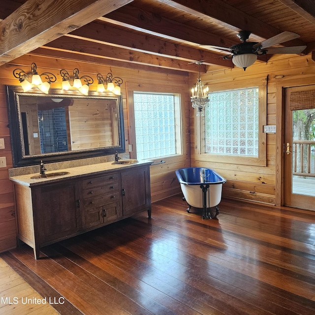 bathroom featuring beam ceiling, a bathing tub, and hardwood / wood-style flooring