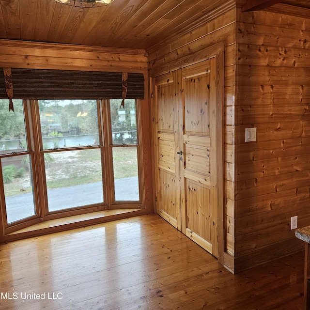 entryway featuring wood-type flooring, wooden walls, and wood ceiling