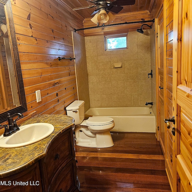 full bathroom with wooden walls, vanity, hardwood / wood-style flooring, and toilet