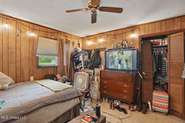 9 Gail St, Hattiesburg, MS 39402 - bedroom with wood walls, a closet, and a ceiling fan