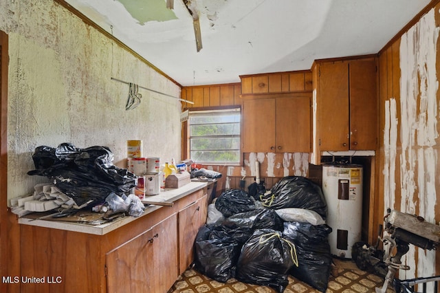 9 Gail St, Hattiesburg, MS 39402 - kitchen with water heater, brown cabinetry, and light countertops