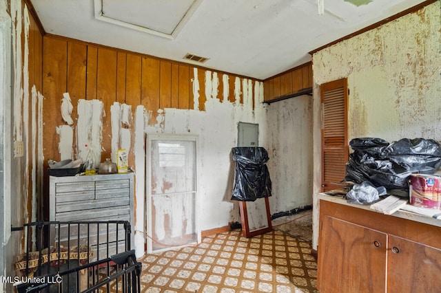9 Gail St, Hattiesburg, MS 39402 - kitchen with light flooring, brown cabinetry, light countertops, and wooden walls