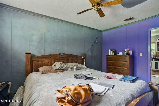 9 Gail St, Hattiesburg, MS 39402 - bedroom with a textured ceiling and a ceiling fan