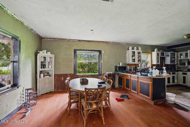 9 Gail St, Hattiesburg, MS 39402 - dining area featuring wood finished floors, a textured ceiling, and a textured wall