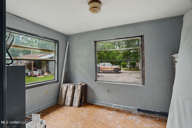 9 Gail St, Hattiesburg, MS 39402 - unfurnished room with plenty of natural light, a textured ceiling, a textured wall, and baseboards