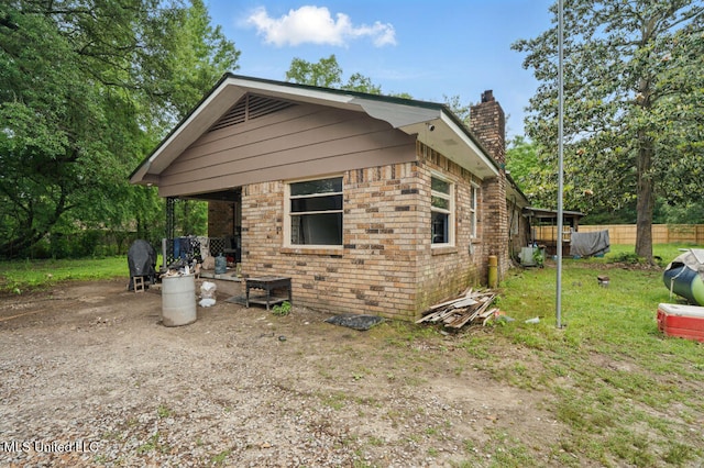 9 Gail St, Hattiesburg, MS 39402 - view of side of property with a chimney and brick siding