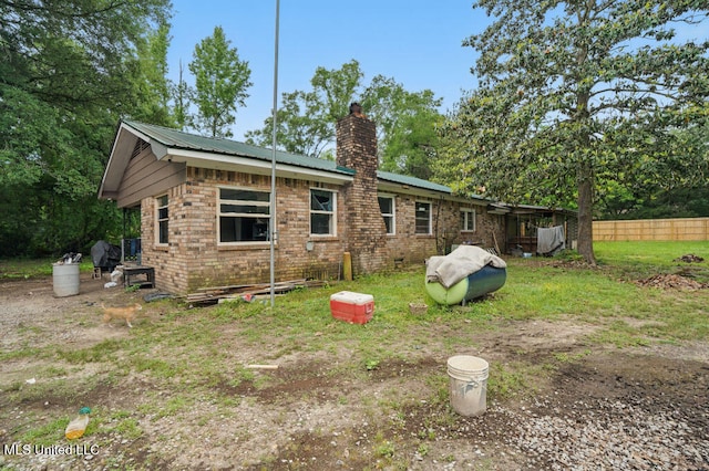 9 Gail St, Hattiesburg, MS 39402 - rear view of house with a chimney, brick siding, and metal roof