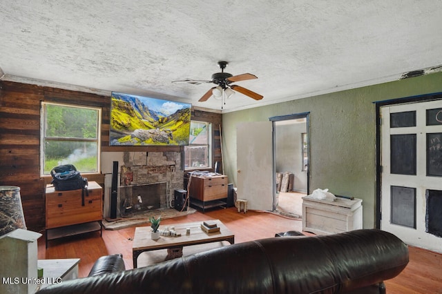 9 Gail St, Hattiesburg, MS 39402 - living area featuring a textured ceiling, a ceiling fan, wood finished floors, a fireplace, and a textured wall