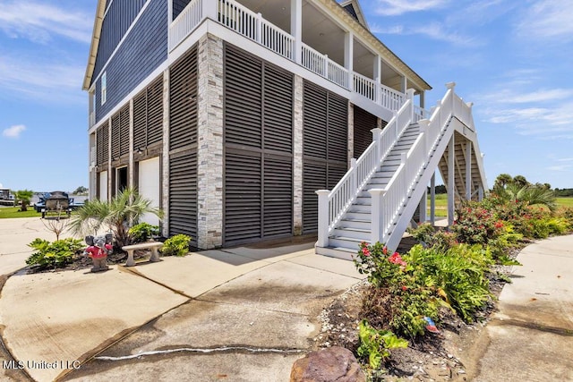 15225 Branigar, Biloxi, MS 39532 - view of building exterior with a garage, driveway, and stairway