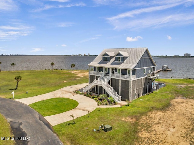 15225 Branigar, Biloxi, MS 39532 - rear view of house with stairs, a water view, and a lawn