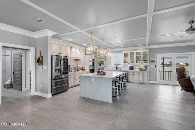 15225 Branigar, Biloxi, MS 39532 - kitchen with appliances with stainless steel finishes, coffered ceiling, a breakfast bar area, recessed lighting, and premium range hood